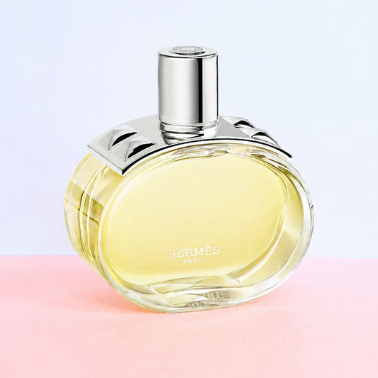 Authentic Hermes Barenia perfume bottle on pink and white background 