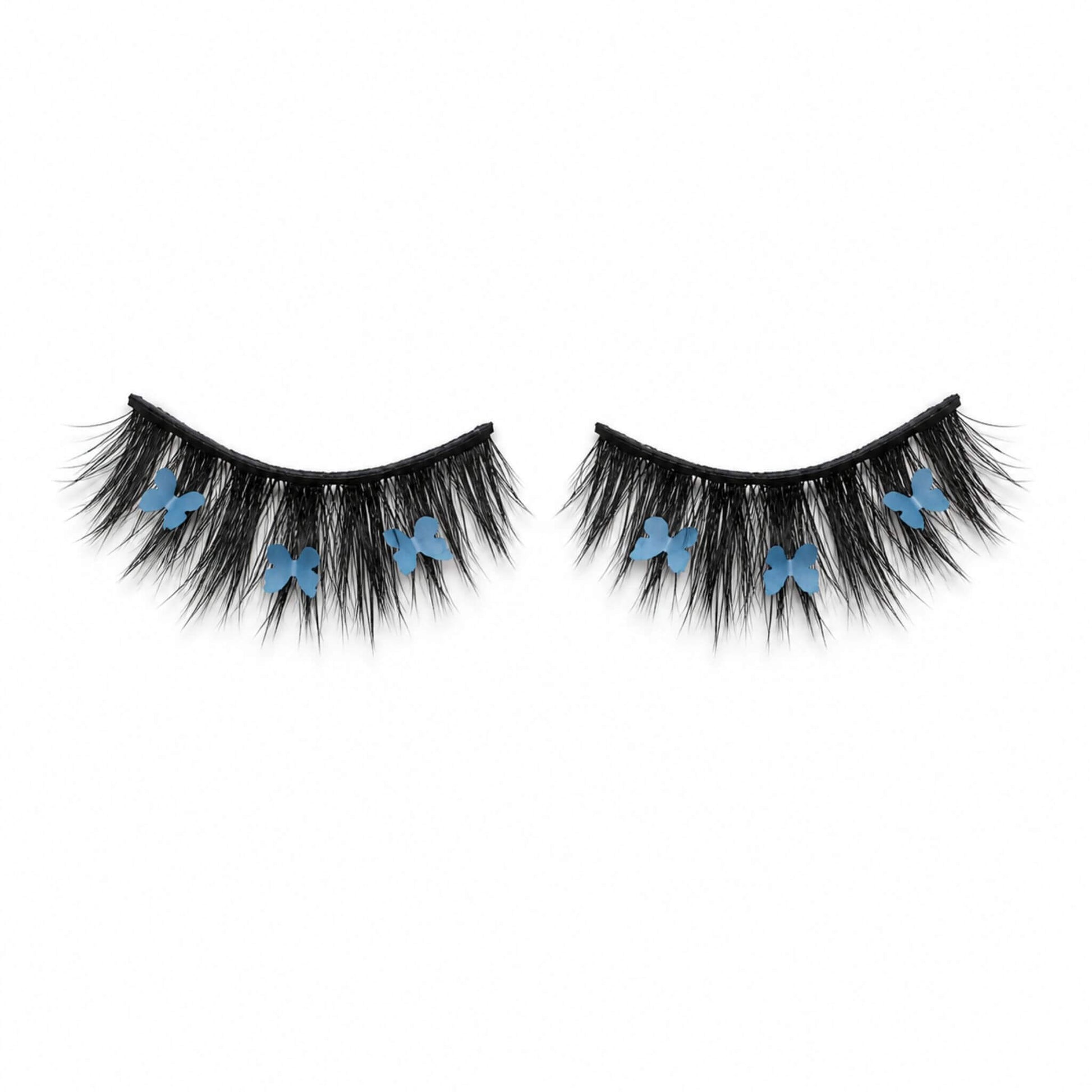 CHRYSALIS blue butterfly lash on white background, showing wispy black lashes and blue butterfly details.