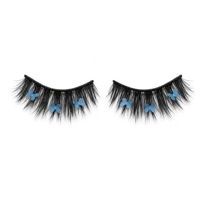 CHRYSALIS blue butterfly lash on white background, showing wispy black lashes and blue butterfly details.