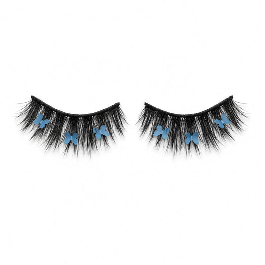 CHRYSALIS blue butterfly lash on white background, showing wispy black lashes and blue butterfly details.