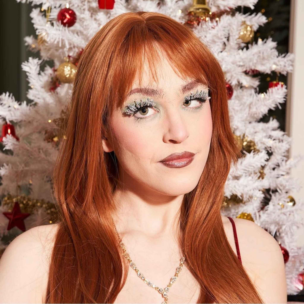 Silver glitter eyelashes on copper hair model